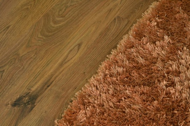 Brown shaggy carpet on wooden floating floor