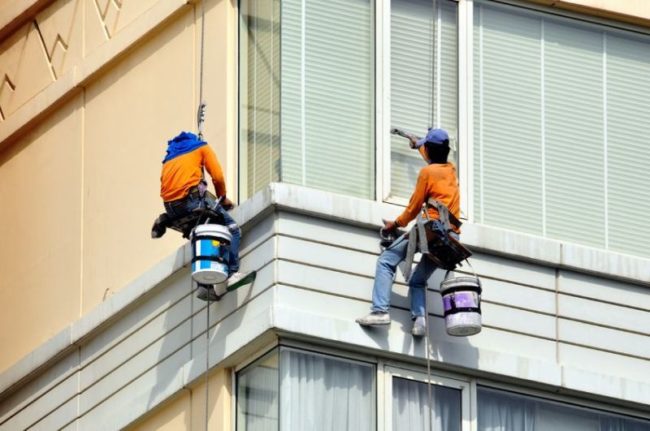 11864274 - two men washes skyscraper's facade